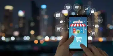 Smartphone displaying a mobile e-commerce app with various products and shopping cart icons, symbolizing US mobile e-commerce trends.